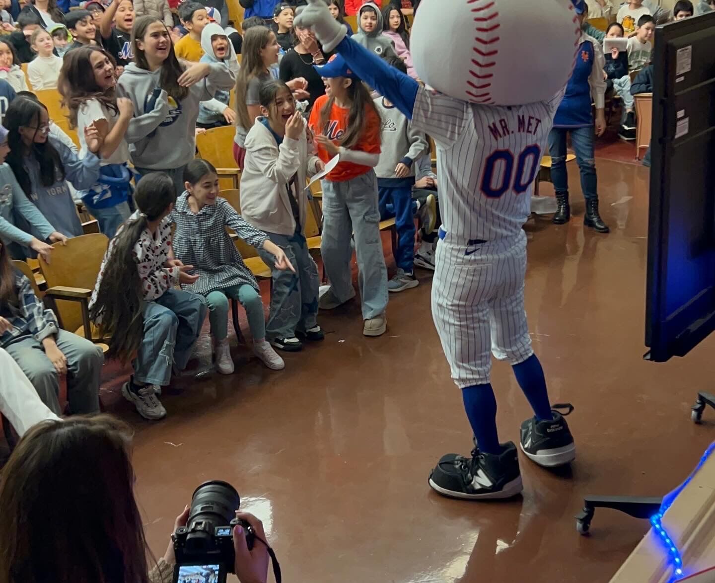 Mr. Met mascot visiting PS 139Q — excited students in the auditorium